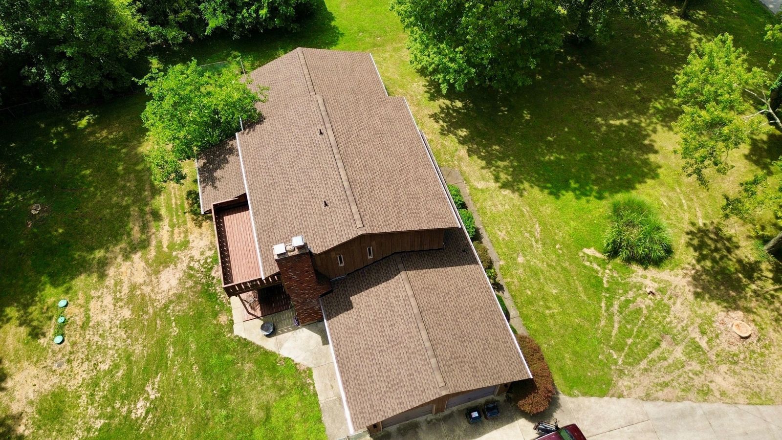 Home Tucked in Wooded Lot Gets a Roof Upgrade - view 2